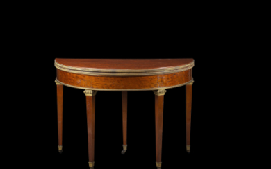 A mahogany veneered demilune table with folding top, gilt-bronze mounts. Stamped with Fontainebleau castle marks. A drawer stamped P. Marcion....