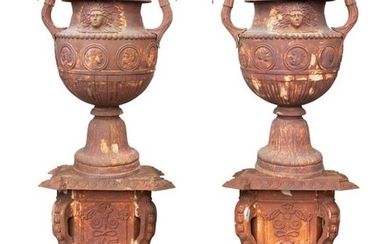 A PAIR OF MONUMENTAL FRENCH CAST IRON URNS AND PED…