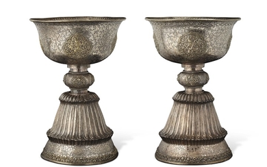 A PAIR OF PARCEL-GILT SILVERED METAL BUTTER LAMPS, TIBET, 18TH CENTURY OR LATER