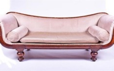 A William IV mahogany scroll end settee with carved show wood frame, and upholstered arms back and seat with loose cushions,...