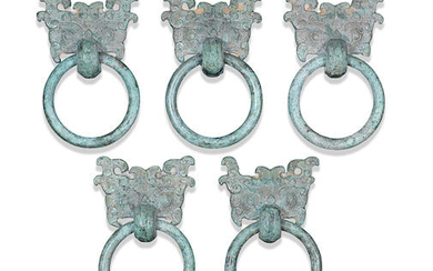 A set of five archaic bronze 'Taotie mask' ring handles, pushou