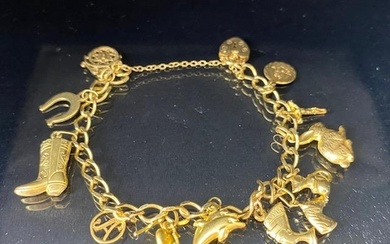 9Ct Gold charm bracelet with a collection of 9ct gold charms...