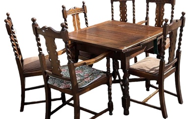A 1920s oak draw-leaf dining table on barley twist supports,...