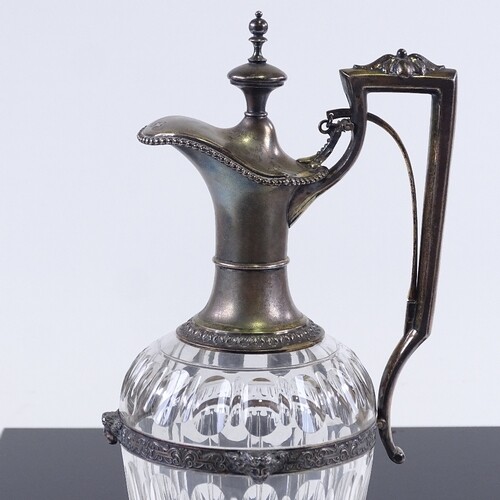 A 19th century German cut-glass claret jug, silver gilt moun...