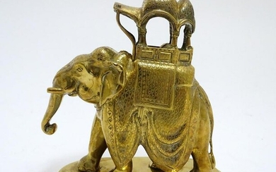 A 20thC brass elephant carrying a decorated howdah.