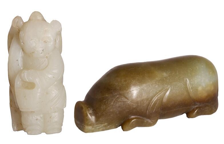 A CHINESE ARCHAISTIC JADE PIG - carved as a...