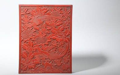 A CHINESE CINNABAR LACQUER RECTANGULAR 'PARADISE FLYCATCHERS' BOX AND COVER. Ming Dynasty. The cover carved with a pair of exotic birds perched on the branches of a pomegranate bush sprouting from rockwork, the sides with flower heads, all against a...