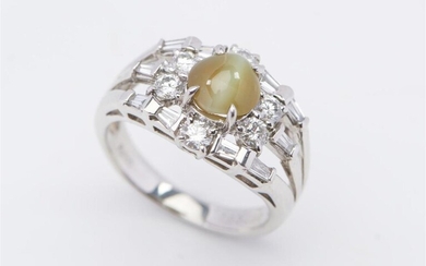 A CHRYSOBERYL AND DIAMOND RING IN PLATINUM, FEATURING A CABOCHON CUT CHRYSOBERYL OF 1.83CTS, WITHIN A SURROUND OF DIAMONDS TOTALLING...