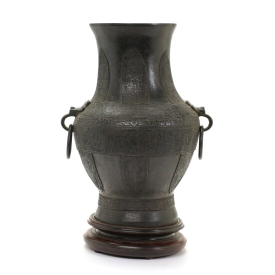 NOT SOLD. A Chinese "Hu" bronze vessel cast in arcaistic style with taotie ring handles...