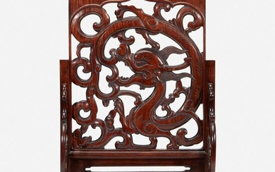 A Chinese carved and pierced huanghuali "dragon" panel