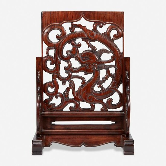A Chinese carved and pierced huanghuali "dragon" panel
