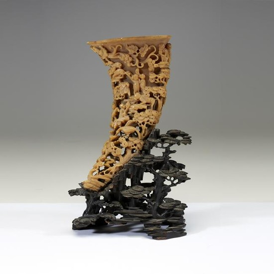 A Chinese carved buffalo horn libation cup on stand