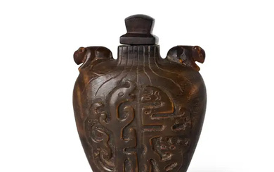 A Chinese horn snuff bottle 19th century Of tapered form, the flattened...