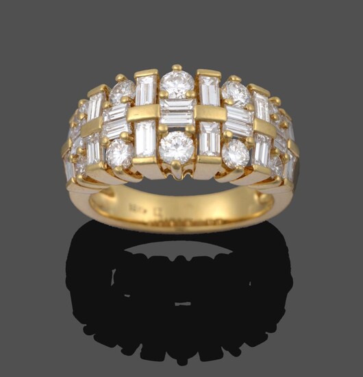 A Diamond Ring, pairs of graduated baguette cut diamonds running parallel to the shank spaced...