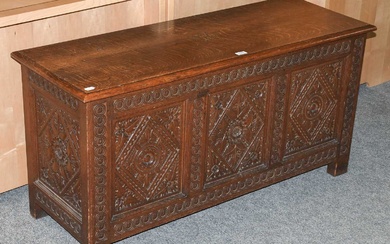 A Early 20th Century Carved Oak Coffer, the top dated...