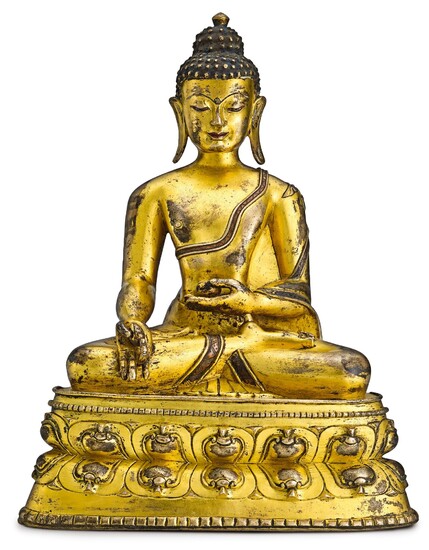 A GILT-BRONZE AND COPPER-INLAID FIGURE OF MEDICINE BUDDHA TIBET, 13TH – 14TH CENTURY