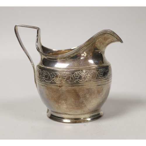 A George III engraved silver helmet shaped cream jug, Andrew...