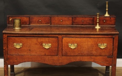 A George III vernacular oak low dresser, rectangular top app...