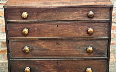 A Georgian mahogany chest of four graduated drawers, raised ...