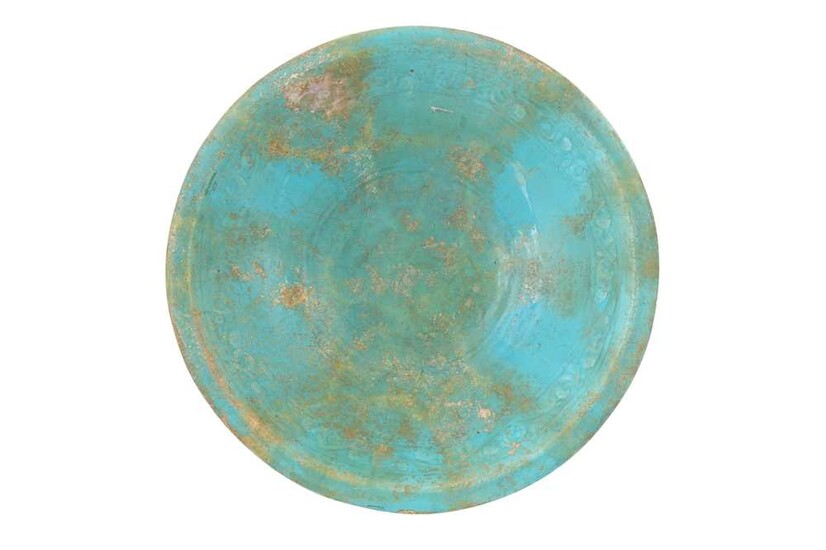 A LARGE TURQUOISE MONOCHROME-GLAZED POTTERY DISH Possibly Kashan, Iran, 10th - 12th century
