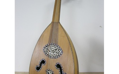 A Middle Eastern Oud guitar, ornately inlaid, complete, requ...