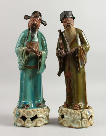 A PAIR OF 19TH CENTURY CHINESE POTTERY SCHOLARS. 15ins