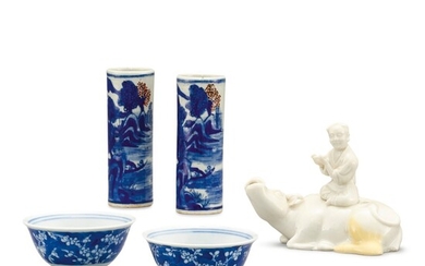 A PAIR OF BLUE AND WHITE CUPS, A PAIR OF TAPER HOLDERS AND A DEHUA 'BOY ON BUFFALO' WATERPOT QING DYNASTY | 清 青花梅花紋小盃一對、青花釉裏紅山水人物圖花插一對 及 德化白釉臥牛童子水丞