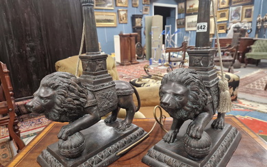 A PAIR OF BRONZE LION TABLE LAMPS, EACH STANDING WITH A FOREPAW RAISED ON A BROCADE BALL, THE