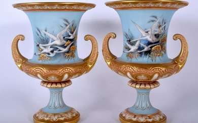 A PAIR OF ROYAL WORCESTER TWIN HANDLED PORCELAIN URN