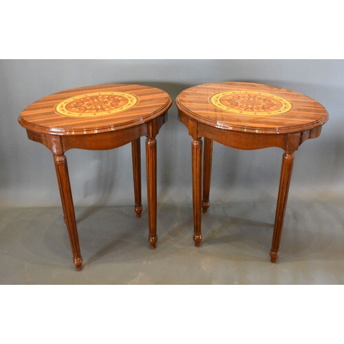 A Pair of French marquetry inlaid oval lamp tables each with...