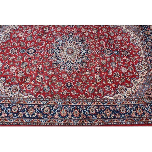 A Persian or Iranian woollen carpet, worked in the tradition...