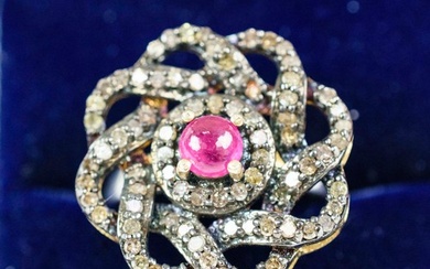 A RUBY AND DIAMOND DRESS RING, white metal shank, the flower...