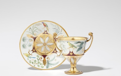 A Royal Vienna porcelain vase and saucer with parrot motifs