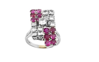 A Ruby and Diamond Cluster Ring a raised round brilliant...