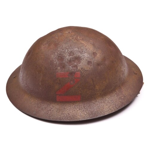 A WWI raw edge Brodie’s pattern steel helmet, red painted b...