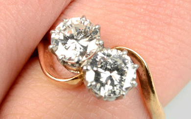 A brilliant-cut diamond two-stone crossover ring.