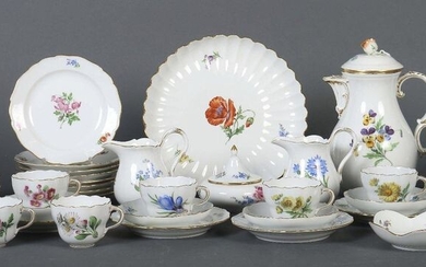 A cake plate, a sugar bowl, a small confectionary bowl and a coffee pot, the pommel of the coffee pot shaped like a rosebud, the cups with ribbon handles, each with underglazed blue marks of swords of the Pfeiffer period on the bottom, as well as...
