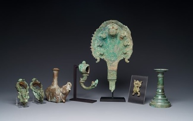 A collection of bronze sculptures, palanquin hooks and a candlestick holder, Cambodia, 13th C. and