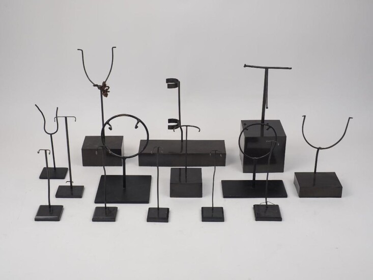 A collection of loose artefact stands of varying sizes and fittings, on plinths and glass bases, tallest 28cm high (lot) Please note: the image illustrates only examples and not the full quantity of this lot