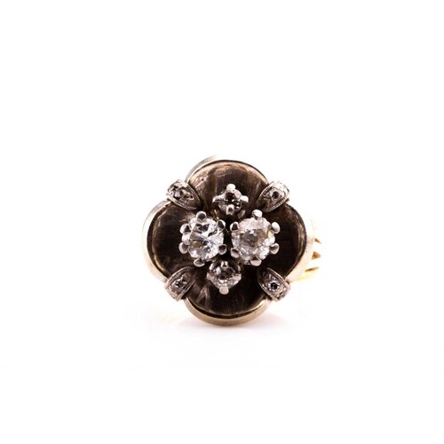 A diamond cluster ring, the white metal mount of quatrefoil ...