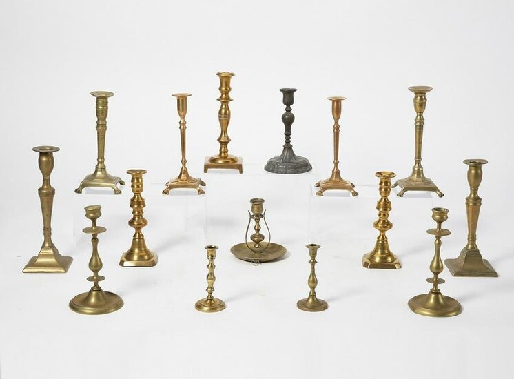 A group of fifteen metalware candlesticks