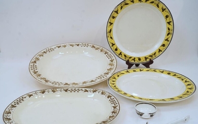A group of five enamelled creamware dinner wares, early 19th century, impressed marks, comprising: a pair of large plates with yellow foliate border, 34.5cm diameter, an oval platter, a large charger, 43cm diameter and a ladle, (5) Provenance:...