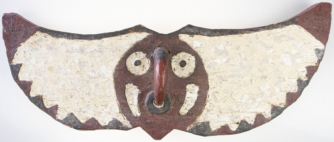 A large painted African mask shaped as a bird