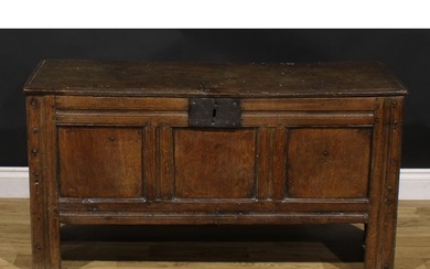 A late 17th century oak blanket chest, hinged top, three pan...