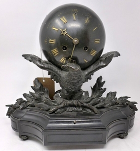 A late 19th century French bronze and slate clock, in the fo...