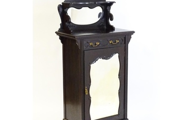 A late Victorian ebonised side cabinet with a mirrored upsta...