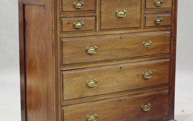 A late Victorian mahogany chest of drawers, fitted with an arrangement of five short drawers above t
