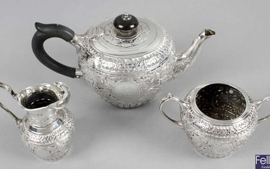A late Victorian silver three piece bachelor tea service.