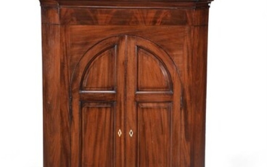 A mahogany standing corner cupboard