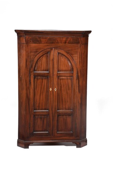 A mahogany standing corner cupboard